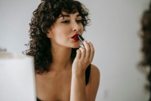 https://www.pexels.com/photo/crop-gentle-woman-making-up-lips-in-front-of-mirror-6001511/