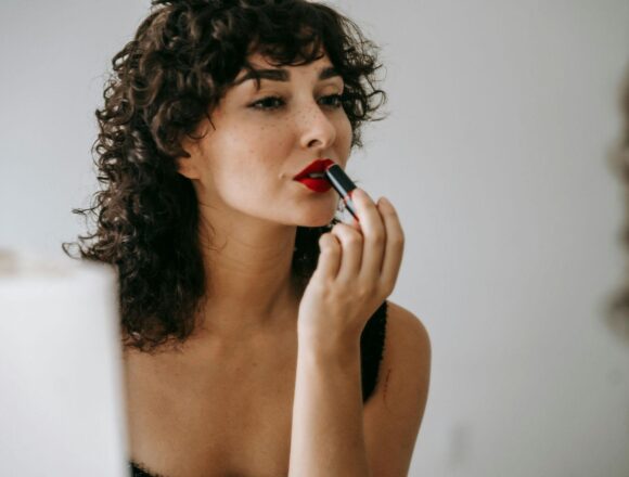 https://www.pexels.com/photo/crop-gentle-woman-making-up-lips-in-front-of-mirror-6001511/